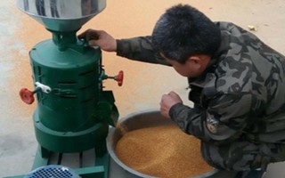 怎么使用碾米机,需要先平稳地将其放在工作台上